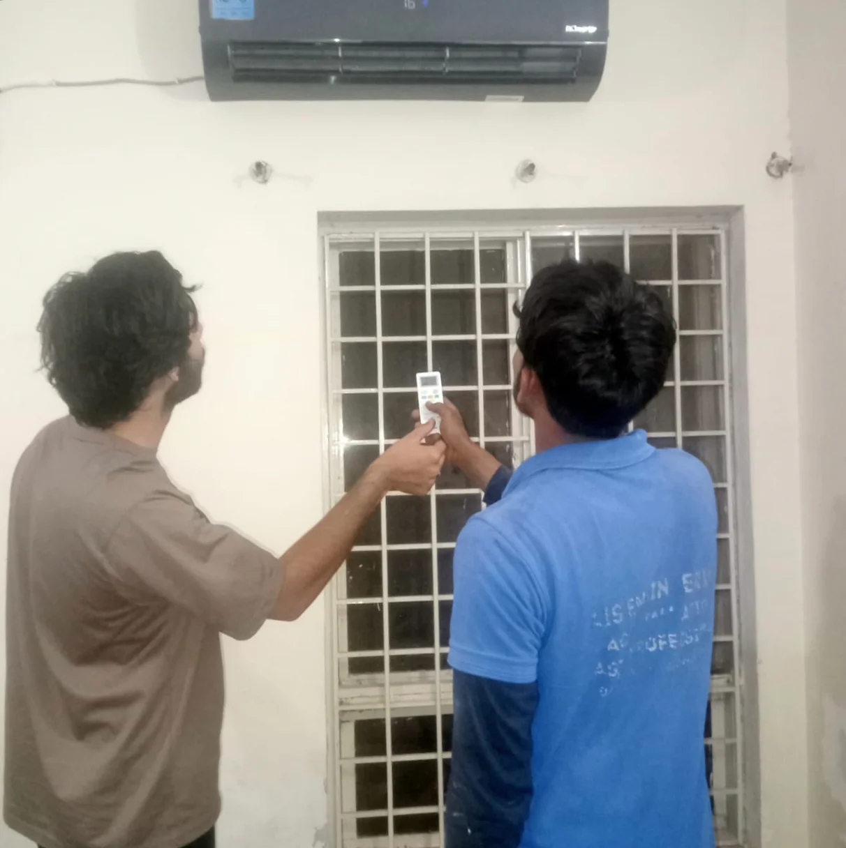 Team working on air conditioner repair