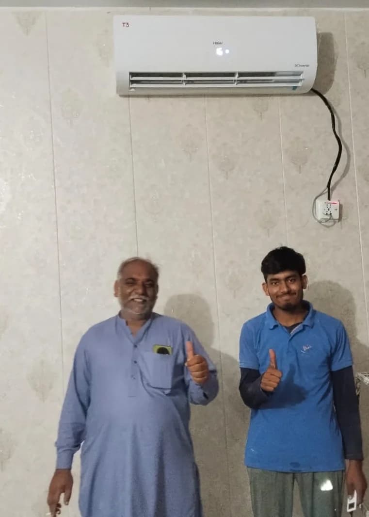 Technician servicing air conditioner unit
